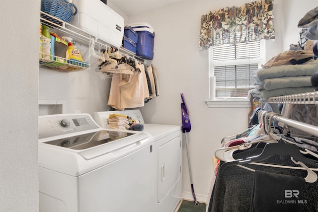 laundry room with baseboards, washing machine and dryer, and laundry area