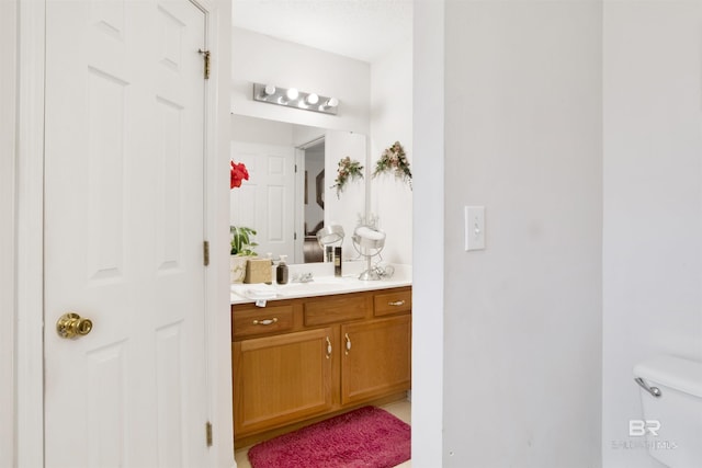 half bath featuring toilet and vanity