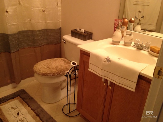 bathroom featuring vanity, tile patterned floors, toilet, and a shower with curtain