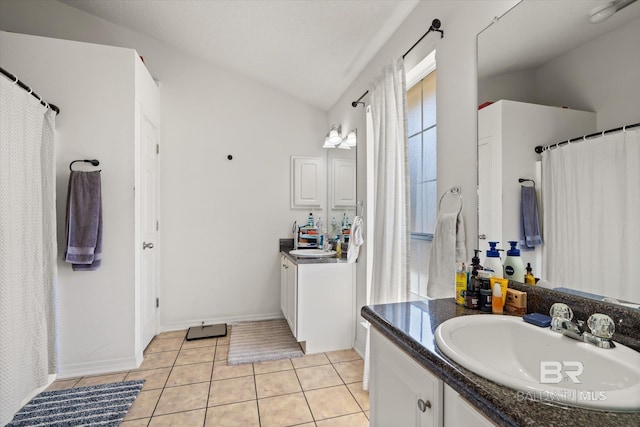 full bath featuring tile patterned floors, a shower with shower curtain, baseboards, vanity, and vaulted ceiling