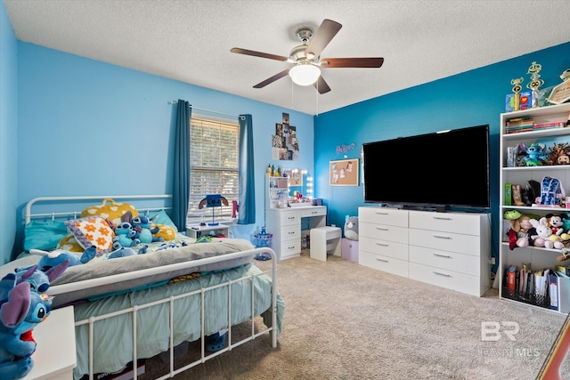 carpeted bedroom with a textured ceiling and a ceiling fan