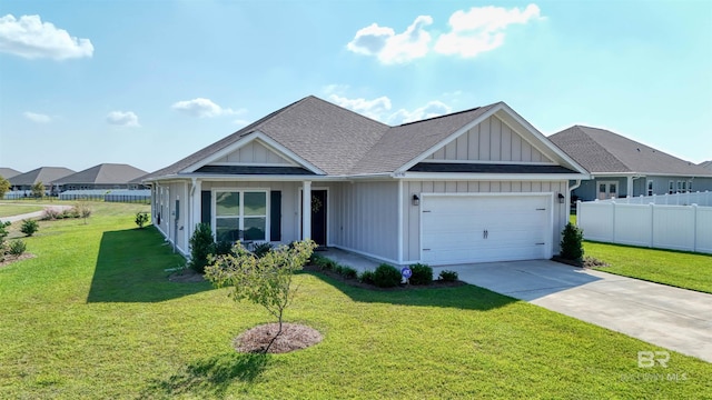 view of front of home with a front yard and a garage