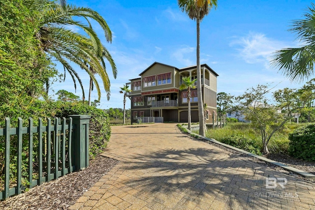 exterior space with fence and a balcony