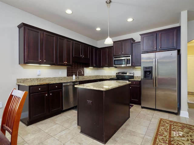 1234 Surrey Loop, Foley, AL 36535 - kitchen featuring appliances with stainless steel finishes, light stone countertops, light tile patterned flooring, a kitchen island, and recessed lighting