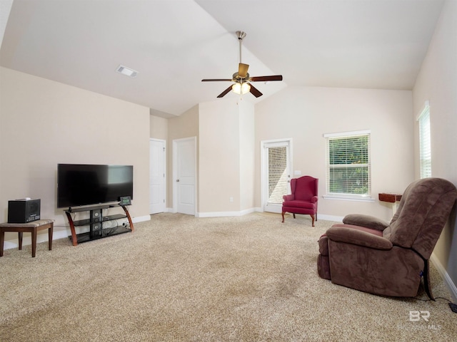 living room with ceiling fan, lofted ceiling, and light carpet