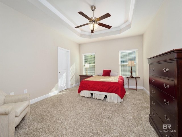 1234 Surrey Loop, Foley, AL 36535 - bedroom with a tray ceiling, light carpet, and a ceiling fan