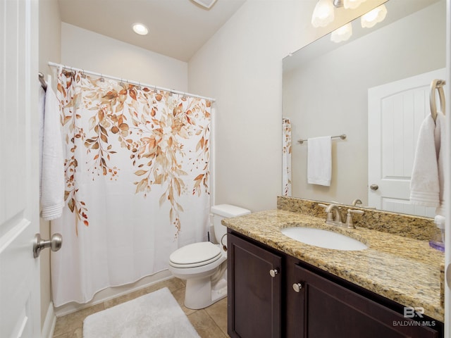 bathroom with tile patterned flooring, vanity, and toilet