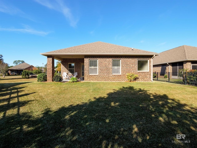 rear view of house with a yard