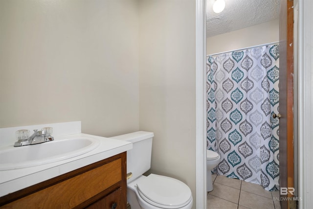 bathroom with vanity, a textured ceiling, toilet, and tile patterned floors