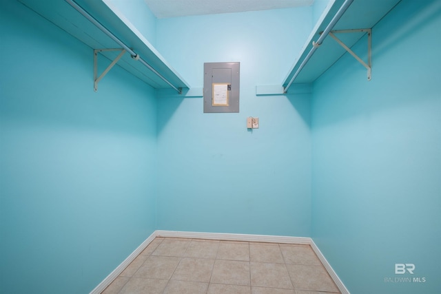 spacious closet featuring light tile patterned floors and electric panel