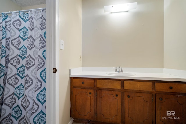 bathroom with vanity and a textured ceiling