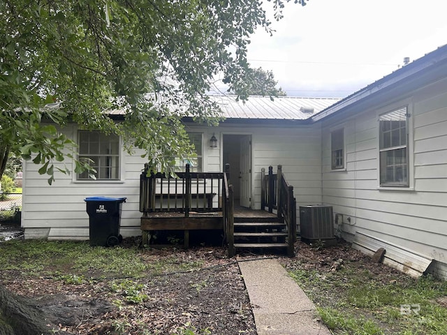 doorway to property with central AC and metal roof