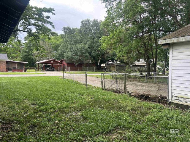 101 8th Ave, Chickasaw, AL 36611 - view of yard with driveway and a carport