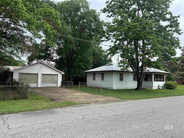101 8th Ave, Chickasaw, AL 36611 - view of front of property featuring a detached garage, an outbuilding, and a sunroom
