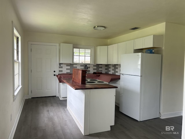 kitchen with freestanding refrigerator, butcher block countertops, white cabinetry, and dark wood finished floors