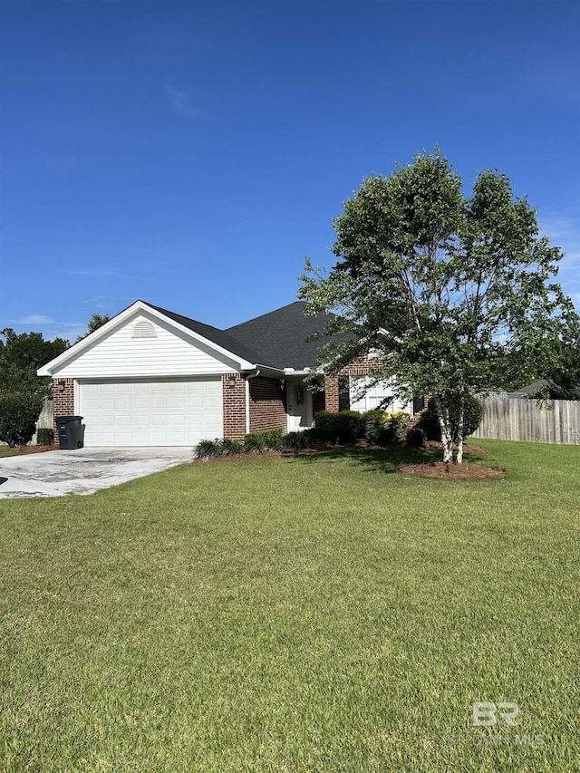 129 Oakwood Ave, Fairhope, AL 36532 - ranch-style home with brick siding, an attached garage, and driveway