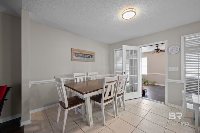 129 Oakwood Ave, Fairhope, AL 36532 - dining space featuring a textured ceiling, a ceiling fan, light tile patterned flooring, and baseboards