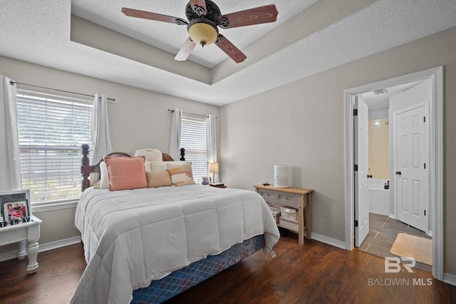 129 Oakwood Ave, Fairhope, AL 36532 - bedroom featuring multiple windows, wood finished floors, and baseboards