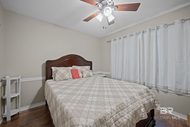 129 Oakwood Ave, Fairhope, AL 36532 - bedroom with baseboards, wood finished floors, and ceiling fan