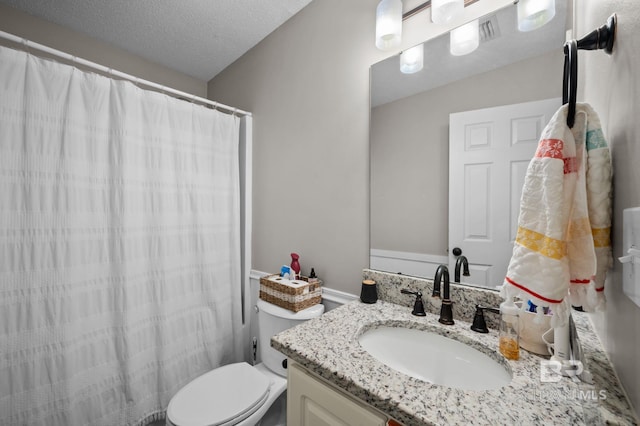 129 Oakwood Ave, Fairhope, AL 36532 - bathroom with vanity, toilet, curtained shower, and a textured ceiling