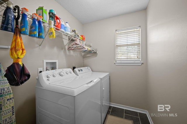 129 Oakwood Ave, Fairhope, AL 36532 - laundry area with washing machine and dryer, tile patterned floors, baseboards, and a textured ceiling
