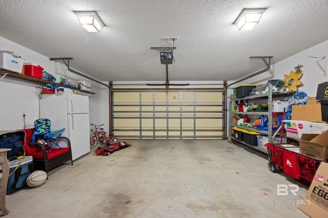 129 Oakwood Ave, Fairhope, AL 36532 - garage featuring freestanding refrigerator and a garage door opener