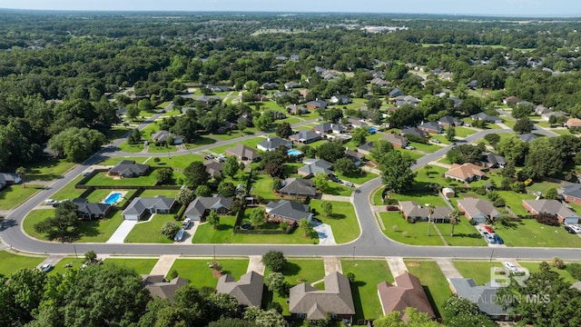 129 Oakwood Ave, Fairhope, AL 36532 - aerial perspective of suburban area featuring a heavily wooded area