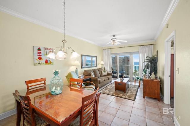 dining space featuring light tile patterned floors, baseboards, crown molding, and ceiling fan with notable chandelier