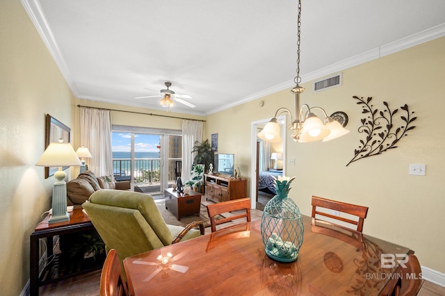 dining area with ceiling fan with notable chandelier, visible vents, baseboards, and ornamental molding