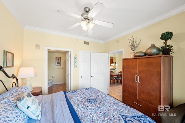 bedroom featuring crown molding, light tile patterned floors, visible vents, ceiling fan, and ensuite bath