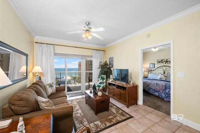 living area featuring ornamental molding, ceiling fan, baseboards, and light tile patterned floors