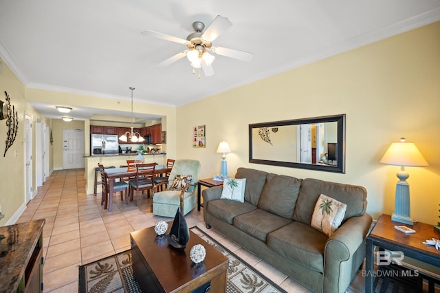 living area featuring ornamental molding, light tile patterned flooring, ceiling fan, and baseboards