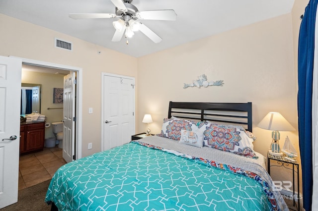 bedroom featuring visible vents, ceiling fan, ensuite bath, and tile patterned floors