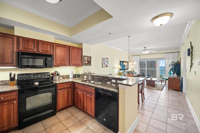 kitchen featuring open floor plan, a peninsula, crown molding, black appliances, and a sink