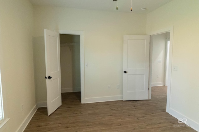 unfurnished bedroom with hardwood / wood-style floors and a closet