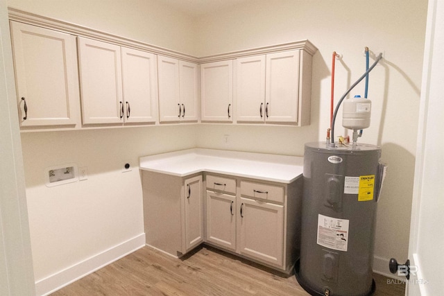 laundry room with cabinets, washer hookup, light wood-type flooring, water heater, and hookup for an electric dryer