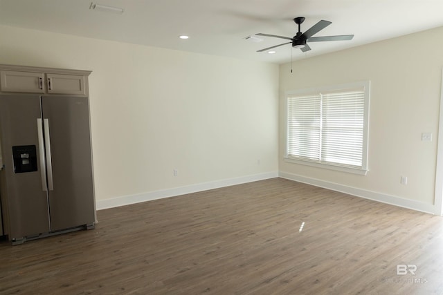 interior space with gray cabinets, stainless steel fridge, hardwood / wood-style floors, and ceiling fan