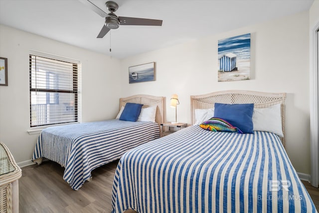 bedroom featuring a ceiling fan, wood finished floors, and baseboards