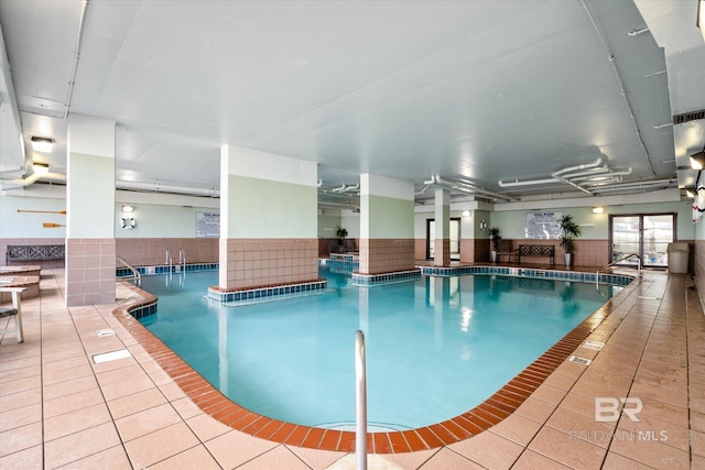 community pool with a ceiling fan and a patio