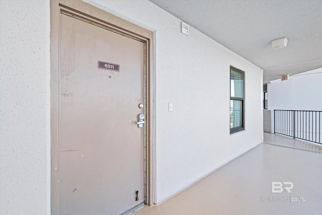 doorway to property featuring stucco siding