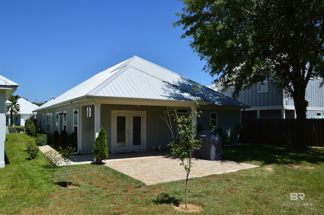 back of house featuring french doors, a yard, and a patio