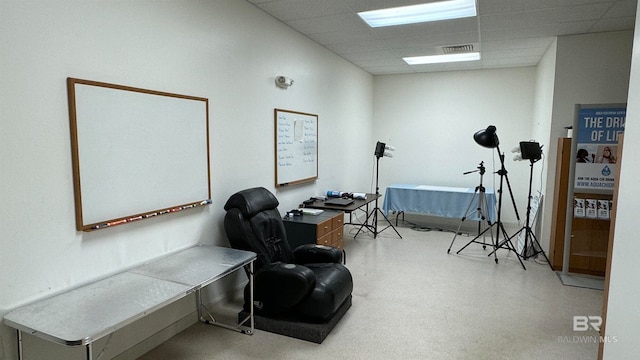 sitting room with a drop ceiling