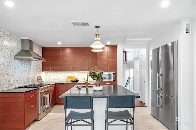 kitchen featuring dark countertops, wall chimney exhaust hood, high quality appliances, and modern cabinets