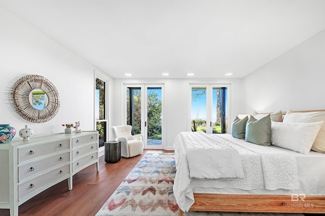 bedroom featuring access to exterior and wood finished floors