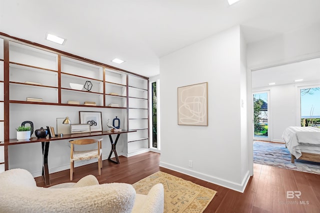 office space featuring dark wood-style flooring and baseboards