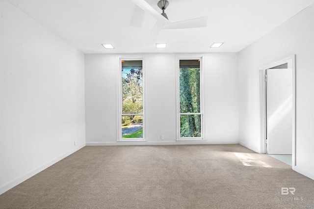 spare room with carpet and baseboards