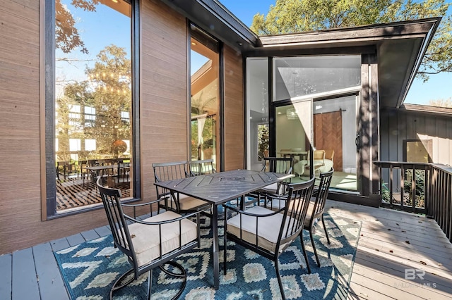 wooden terrace with outdoor dining space