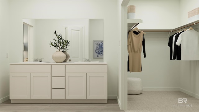 full bathroom featuring a sink, double vanity, and baseboards