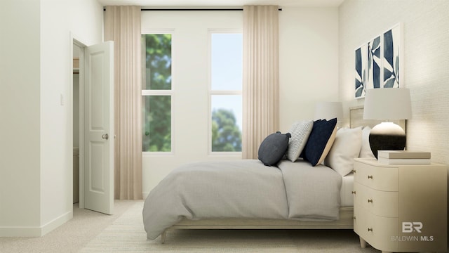 carpeted bedroom featuring baseboards