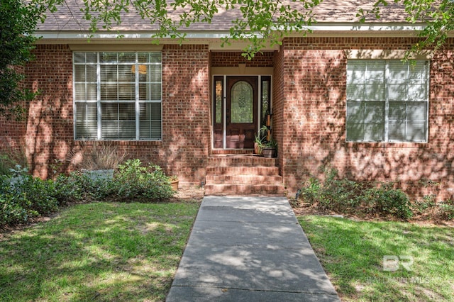 entrance to property with a yard